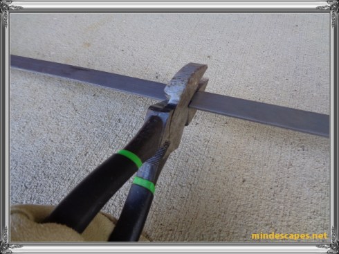 straight cutter on square nosed pliers making an indentation on steel strip