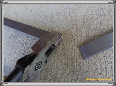 strip steel is now in two pieces, one piece still gripped in pliers